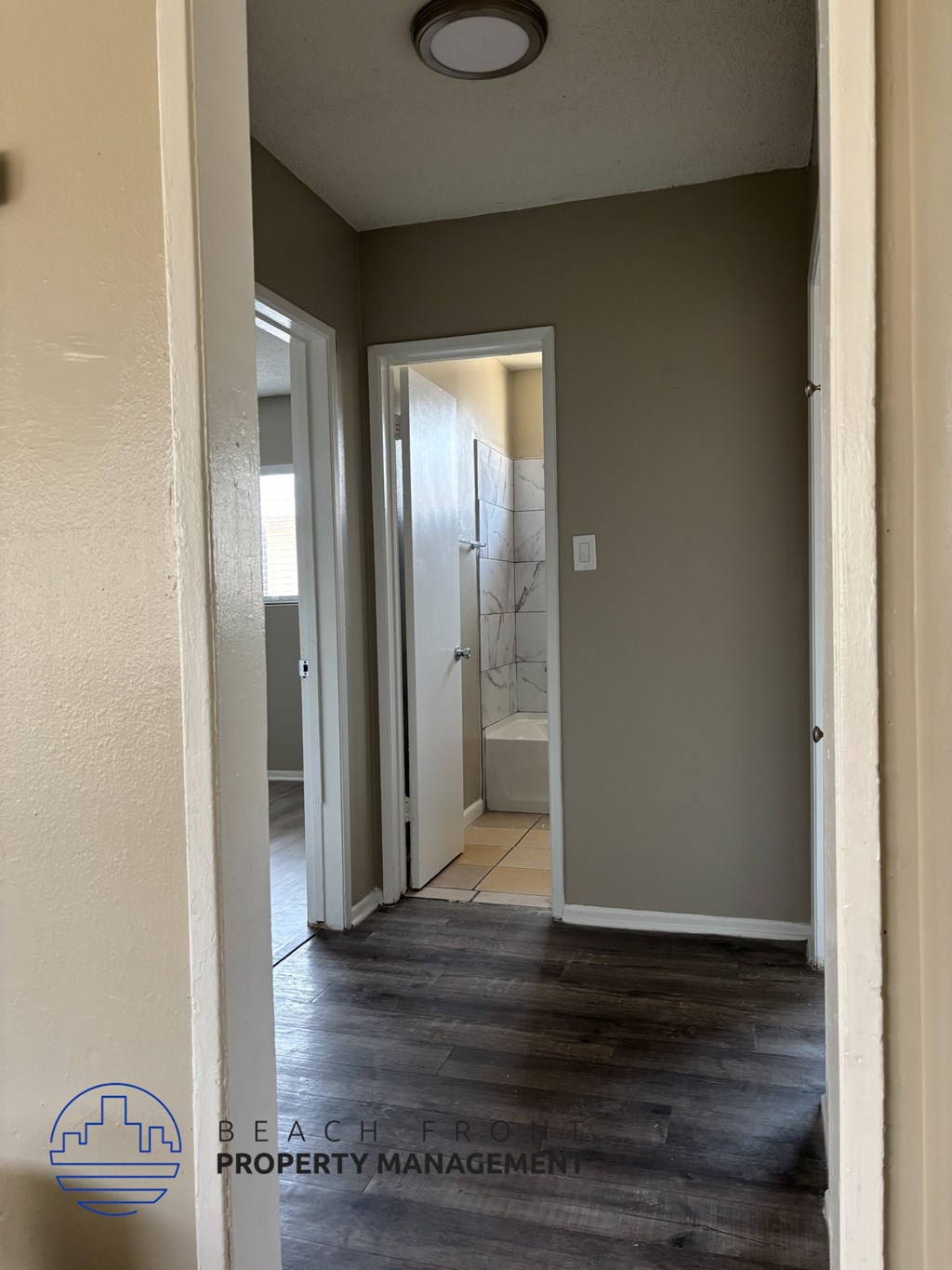 A hallway with a door at the end.